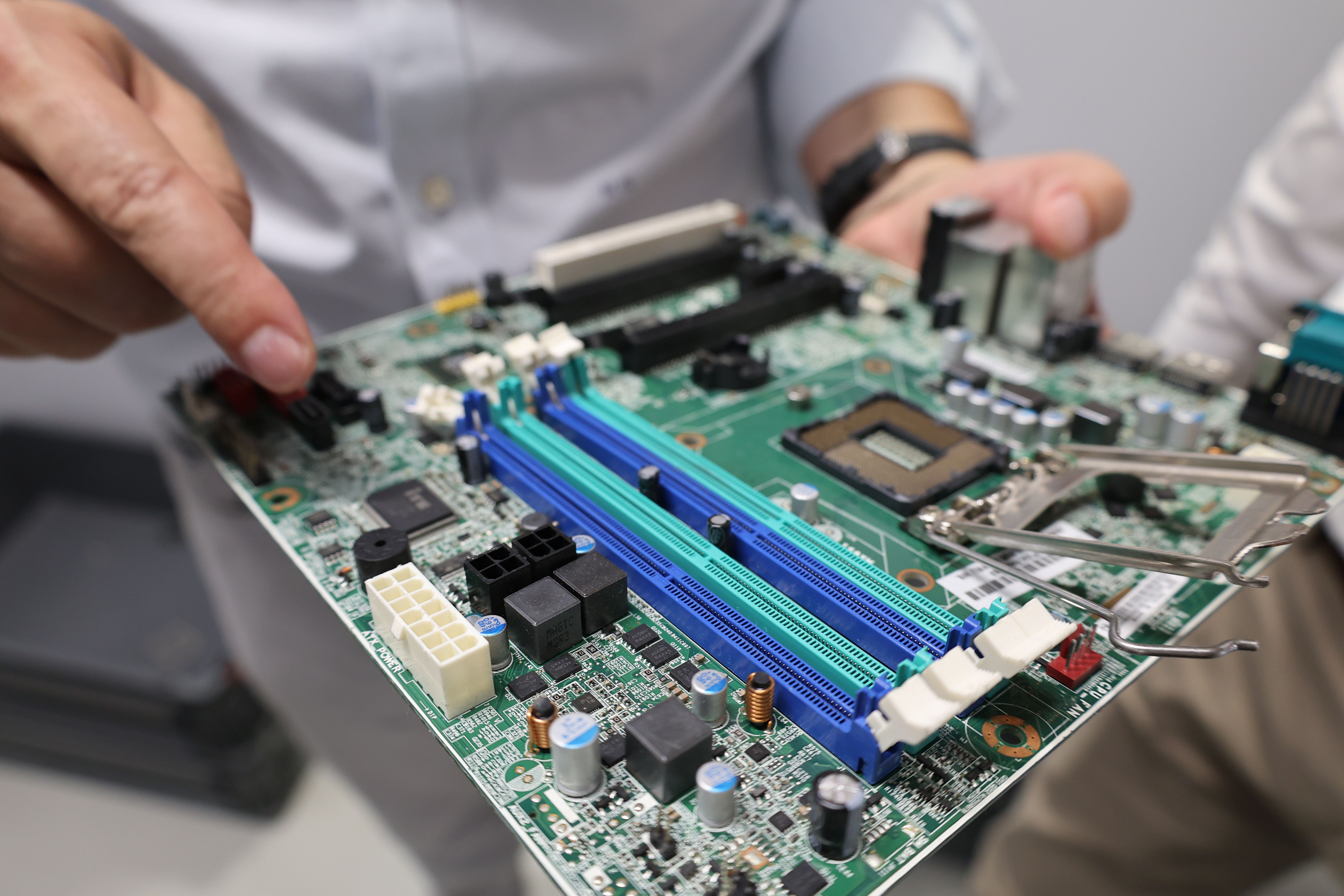 Technician repairing motherboard